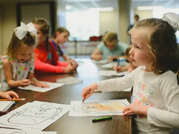 Kids sitting at a table doing crafts. Kids sitting at a table doing crafts.